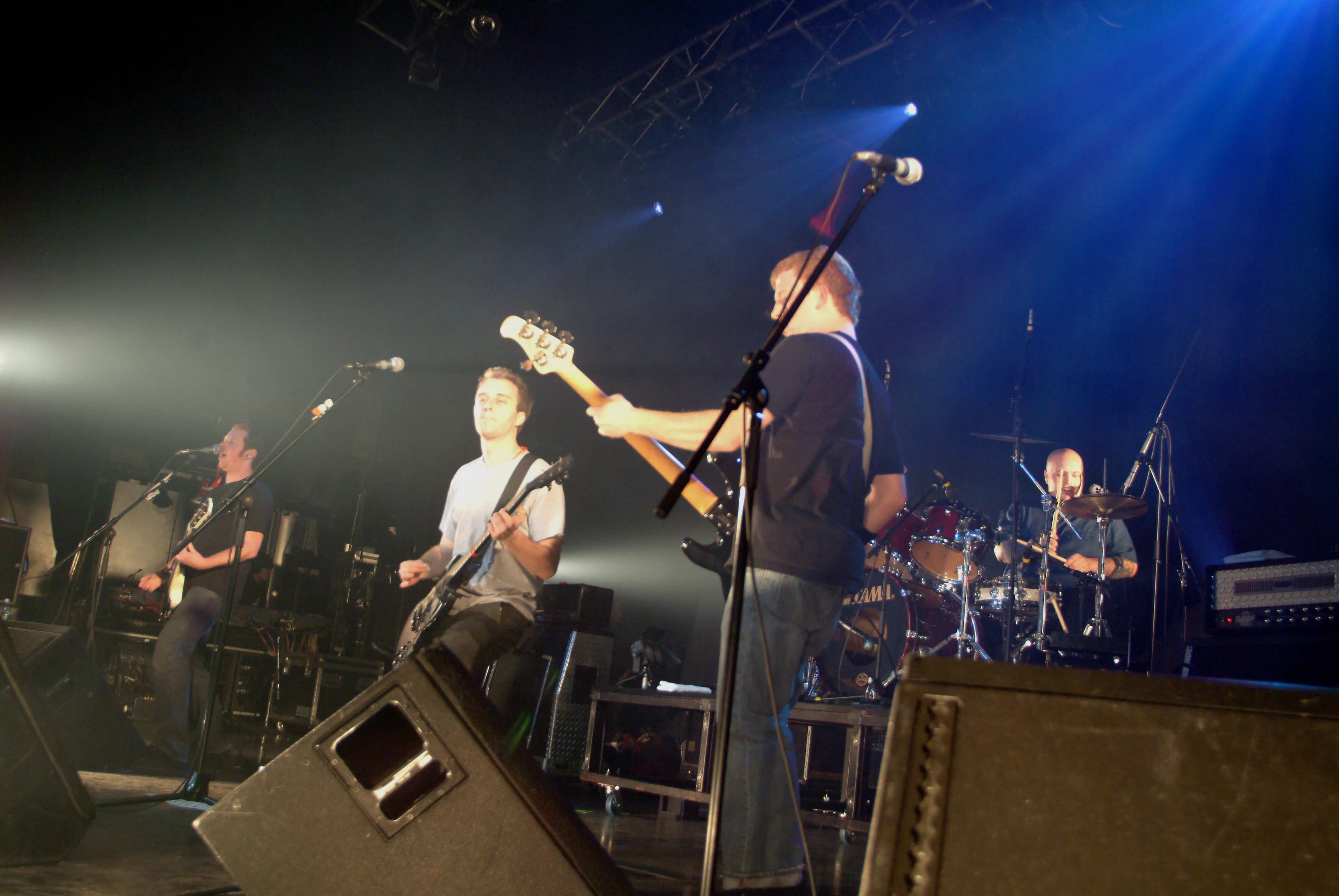 SecondShot playing on stage under blue lights and haze